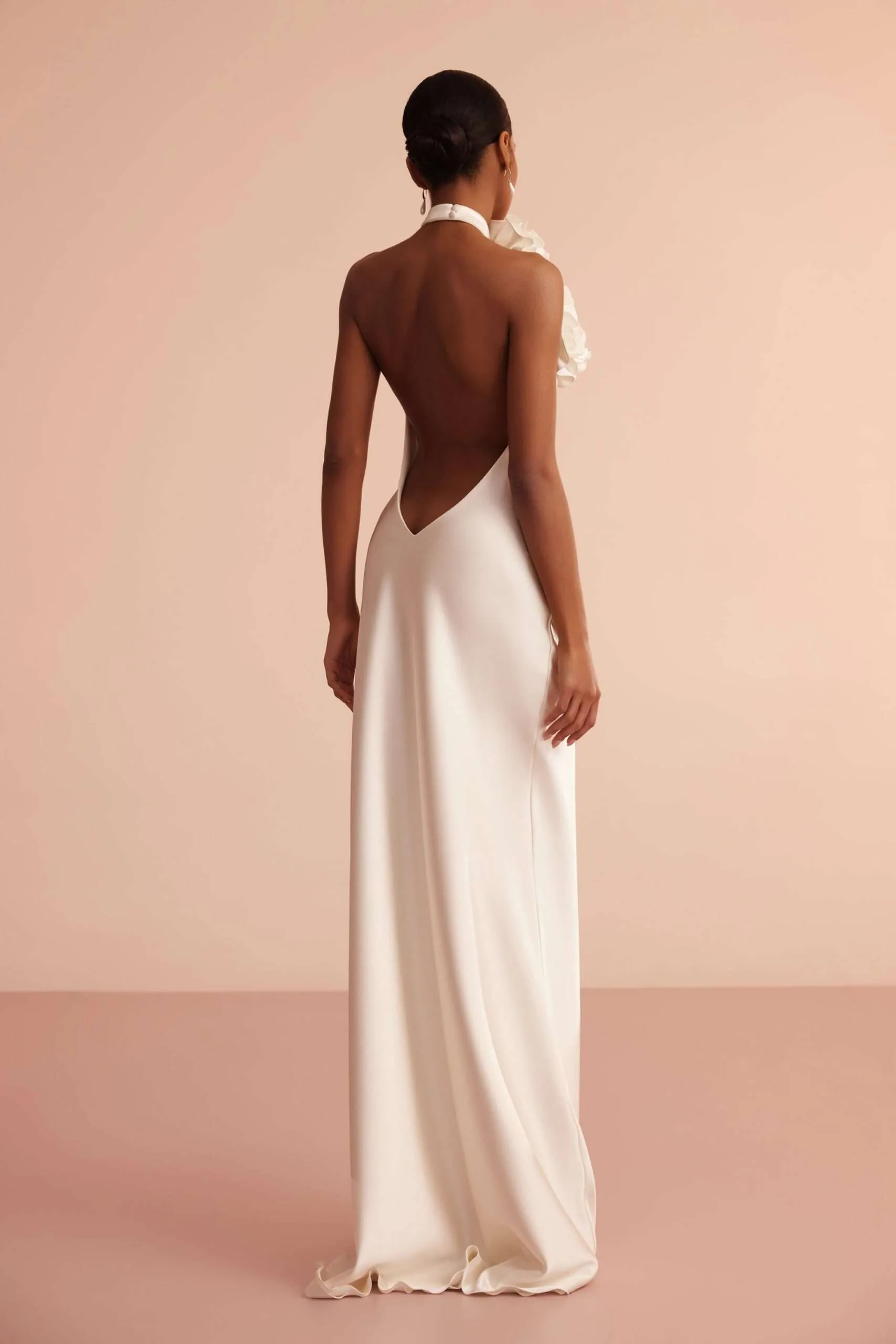 Back view showing the low open back cut to a deep V below the halter collar